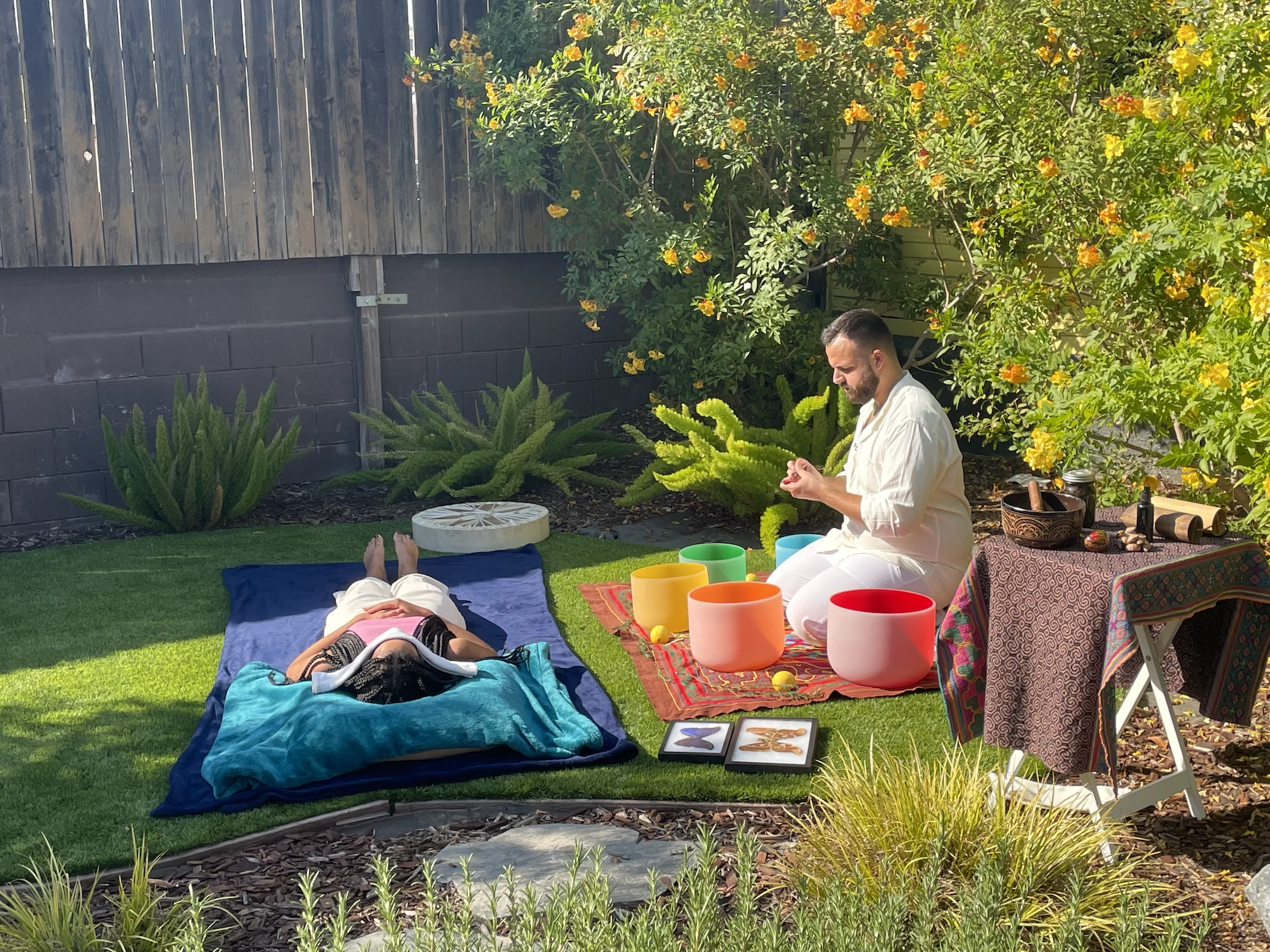 SANTOS with singing bowls in a garden during the NAMI film shoot