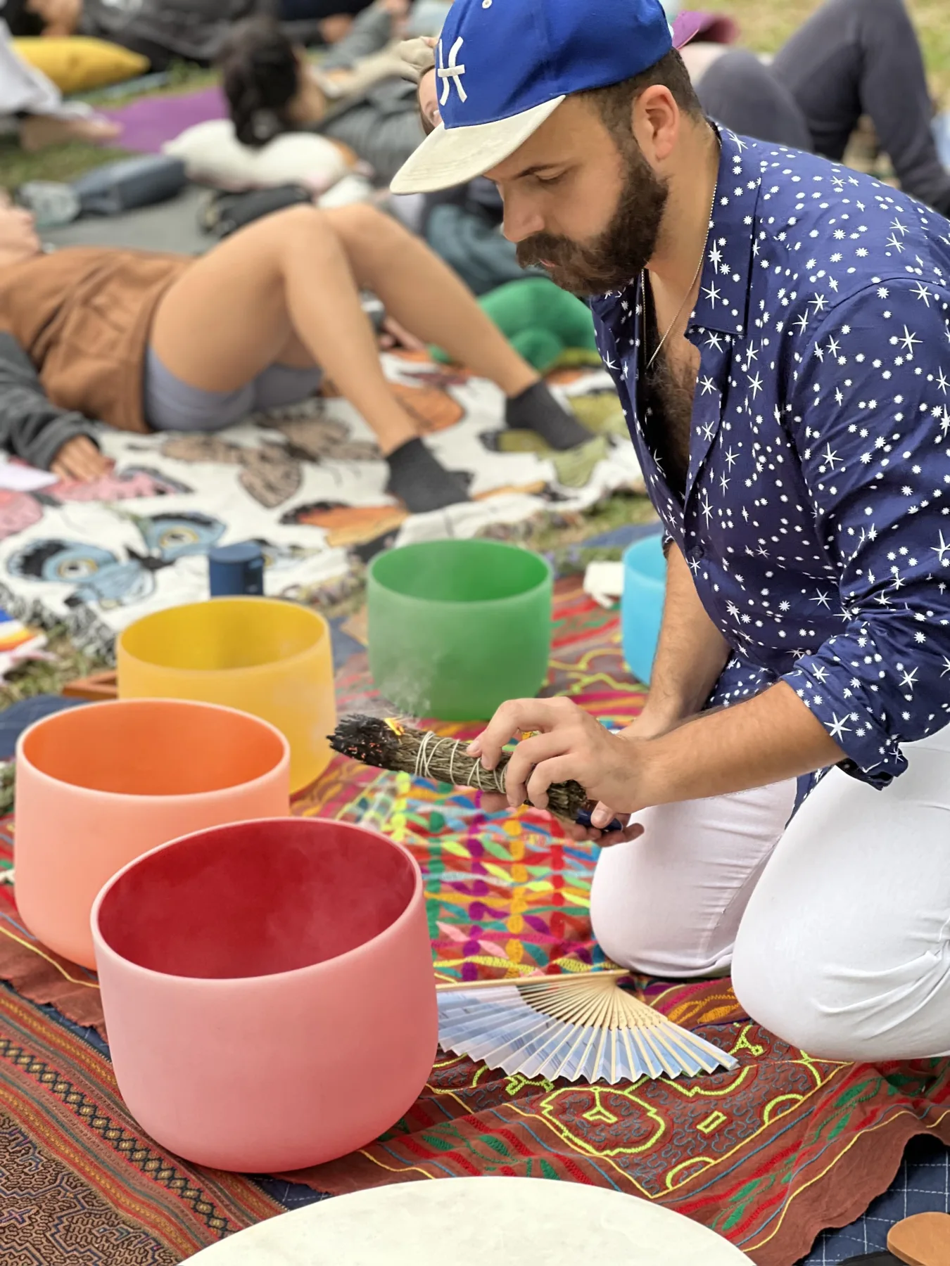SANTOS playing singing bowls at an outdoor gathering in Elysian Park