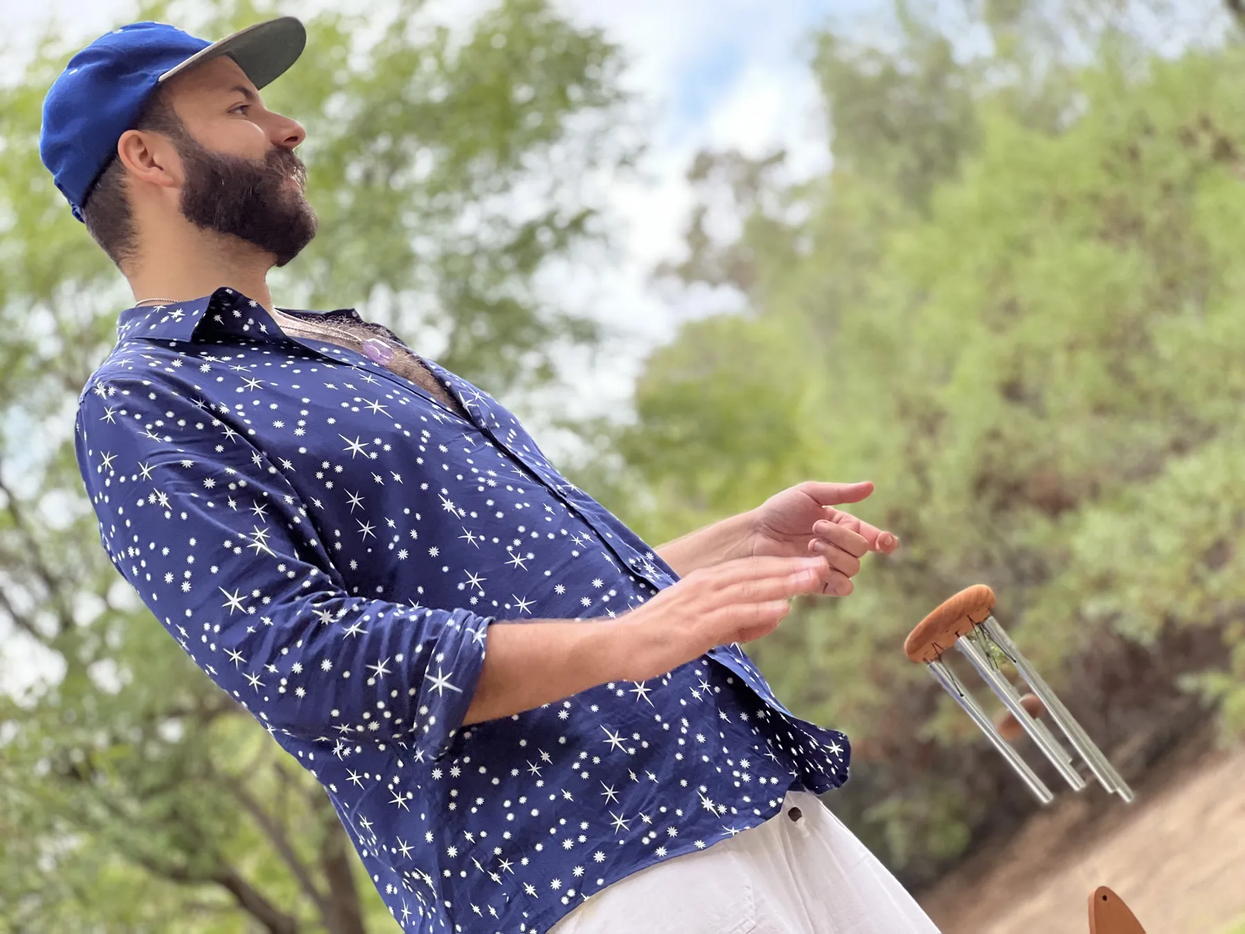 SANTOS sounding handheld chimes beneath the trees in Elysian Park
