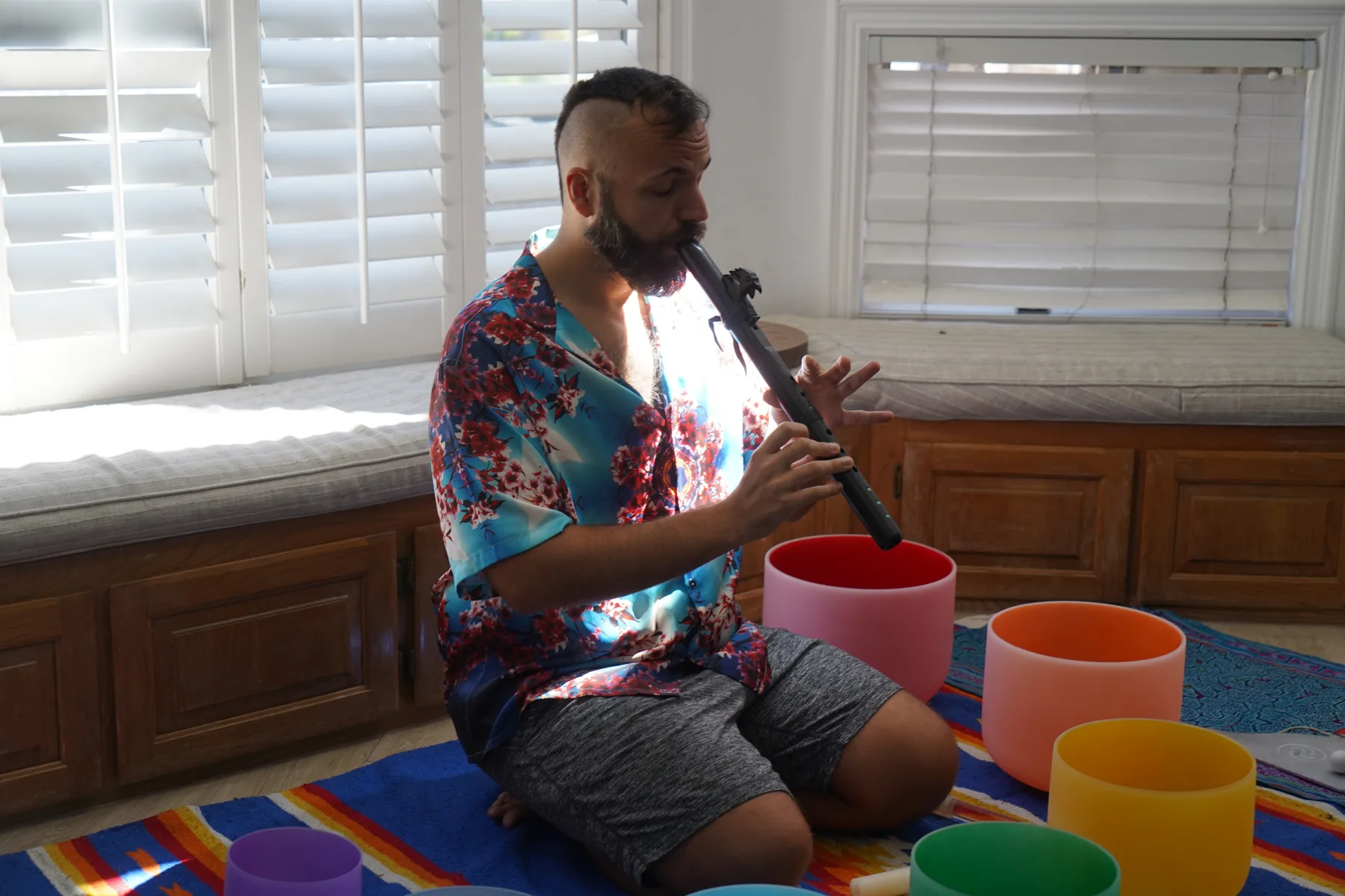 SANTOS playing flute beside singing bowls at Ascension Retreat
